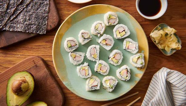 Plato de sushi con wasabi, salsa de soya y aguacate