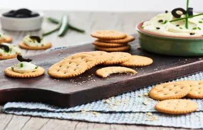 Receta dip de queso crema, aceitunas y cebollin con galletas Ricas®.